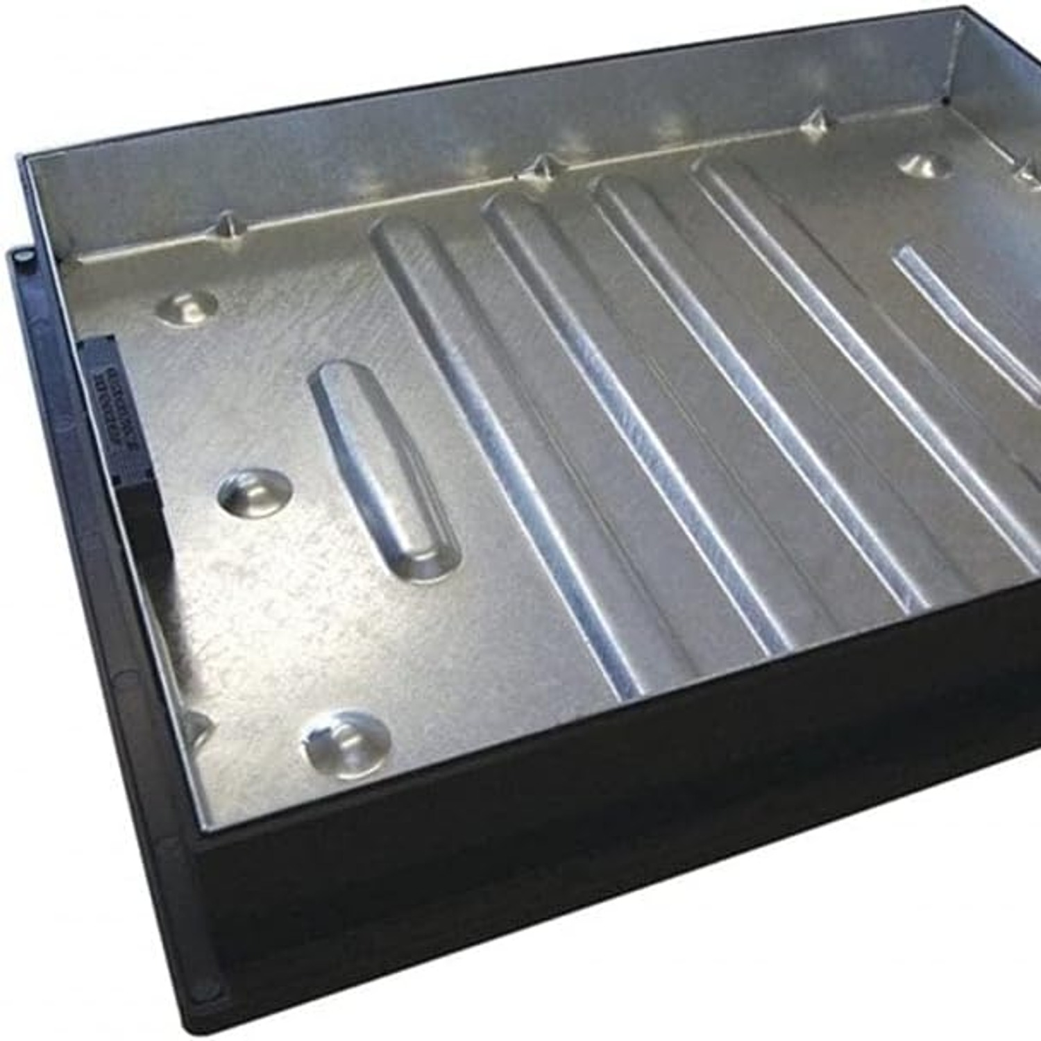 An empty recessed manhole cover tray, ready to fill with block paving